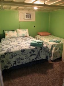 A bed or beds in a room at Rustic BEACH FRONT Basement Apt, Pet Friendly Wi-Fi apts