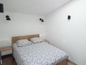 a bedroom with a bed and two pillows on it at Gîte de Léonie Moulin de Tartay en Avignon in Avignon