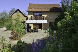 a house with a white awning in a garden at La Parenthèse in Saint-Genix-sur-Guiers