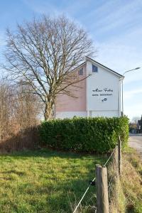 a sign on the side of a building with a tree at Haus Fabry in Hilden