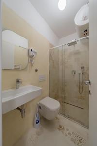 a bathroom with a shower and a toilet and a sink at BG Exclusive Suites in Belgrade