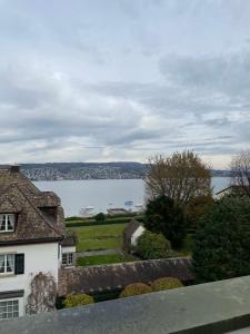 a house with a view of a body of water at Bethaniaweg in Rüschlikon