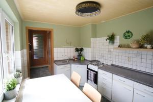 a kitchen with white cabinets and a stove top oven at „Grüne Höhle“ in Schwerin in Schwerin