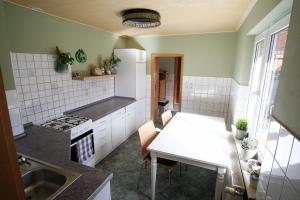 a small kitchen with a white table and a sink at „Grüne Höhle“ in Schwerin in Schwerin