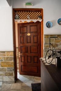 a wooden door with a bicycle in front of it at Studio Sevasti in Kala Nera