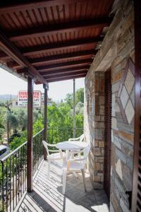 a patio with a table and chairs on a balcony at Studio Sevasti in Kala Nera