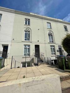 a large white building with a staircase in front of it at Chic & Cosy Studio Apartment in Southampton