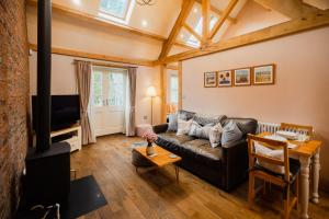 a living room with a couch and a fireplace at White House Barn, near Yarm / Stockton-on-Tees in Yarm