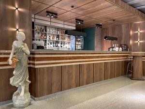 a statue of a woman standing at a bar at Hotel Gloria Deluxe in Borovoye