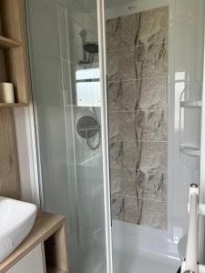 a shower with a glass door in a bathroom at Sea La Vie in Cayton