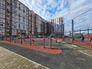 a volley ball net in front of some buildings at Mars APARTMENTS KZ 97 in Aktobe +5 photos