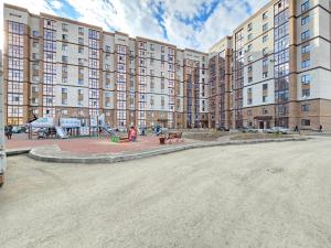 a large apartment building with a playground in front of it at Mars APARTMENTS KZ 97 in Aktobe