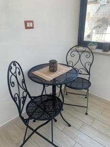 une table et deux chaises avec une tasse dans l'établissement Albero di giada, à Massafra