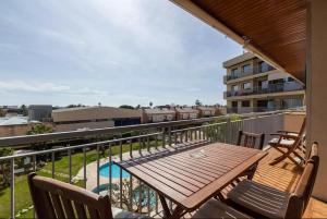 a balcony with a wooden table and chairs at Apartment Muralla in Vilassar de Mar