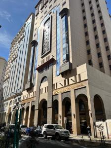 a car parked in front of a large building at Al Andalus Plus in Medina