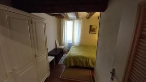 a small bedroom with a bed and a window at Gîte Saumurois 7 personnes in Montreuil-Bellay