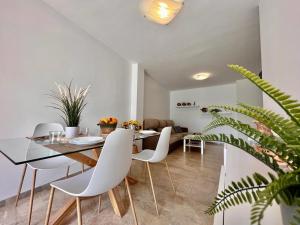 a dining room with a table and white chairs at Casa Pepa by Sun & Sea Homes in Moraira