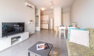 a living room with a couch and a table at Stay Jaffa Jerusalem in Jerusalem