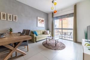 a living room with a table and a couch at Stay Jaffa Jerusalem in Jerusalem