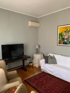 a living room with a bed and a flat screen tv at Golden Ravenna- large appartment in center in Ravenna
