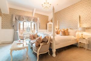 a bedroom with a bed and a couch at Plas Dinas Country House in Caernarfon
