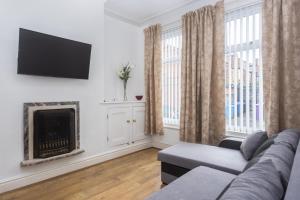 a living room with a couch and a fireplace at Bell Street in Liverpool