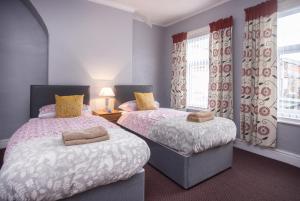 a bedroom with two beds and a window at Bell Street in Liverpool