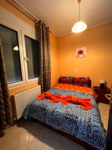 una camera con un letto e una coperta arancione di Teo's House 1 a Kalabaka