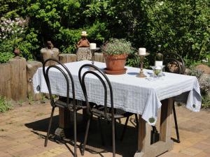 a table with a white table cloth and two chairs at Blue Water 1 in Wustrow
