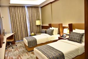 Postel nebo postele na pokoji v ubytování فندق رويال فيستا Royal Vista Hotel