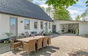 a patio with a table and chairs in front of a house at Stunning Apartment In Billund With Kitchen in Billund