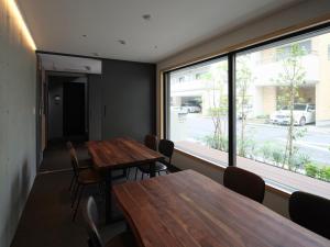 a meeting room with wooden tables and a large window at East SQUARE Tokyo in Tokyo