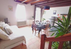 a living room with a dining room table and chairs at quietude in Lagorce