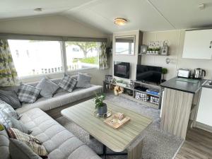 a living room with a couch and a table at Atlas By The Sea - Craig Tara, Ayr in Ayr