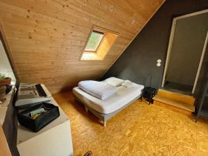 a small bedroom with a bed in a attic at Le Tivoli in Bagnères-de-Bigorre