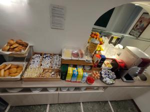 a bakery counter with many different types of donuts at Hotel Tourist House in Florence