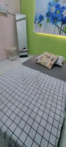a room with a white tiled floor and a refrigerator at Homestay nipah in Bayan Lepas