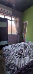 a bedroom with a bed and a window at Homestay nipah in Bayan Lepas