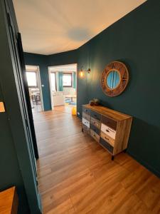 Pokój z drewnianą podłogą i lustrem na ścianie w obiekcie Appartement lumineux centre ville w mieście Châteauroux +1 zdjęcie