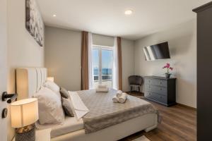 a bedroom with a large bed and a window at Villa Argola in Split