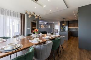 a dining room with a long table and chairs at Villa Argola in Split