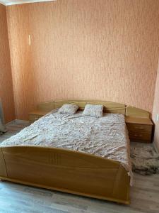 a bed with two pillows on it in a bedroom at Mārkalni in Krāslava