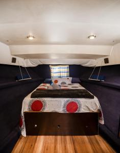 a small bedroom with a bed in a trailer at Spacious and charming BOAT in Port Forum in Barcelona