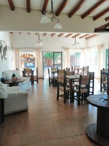 a restaurant with tables and chairs and a room with tables and chairs at Hotel Rural Luna del Valle in San Agustín de Valle Fértil