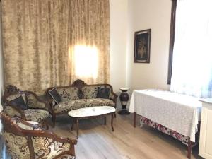 a living room with a couch and a table at ROOMS AND APARTMENTS center of Antalya, beach, old town in Antalya