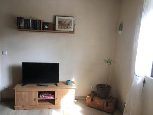 a living room with a flat screen tv on a wooden cabinet at CASA Palatina in Merzalben