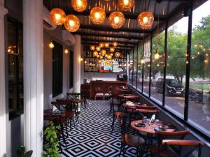 a restaurant with tables and chairs on a patio at HOTEL RIO BENARAS in Varanasi