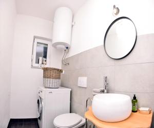 a bathroom with a toilet and a mirror at Stela1 in Drvar