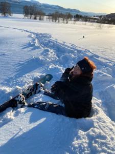 a person is laying in the snow at 3ART recreation in Tromsø