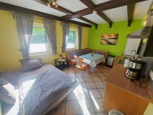 a bedroom with a bed and a table in it at Pension und Ferienwohnungen Bachmann in Wölfersheim
